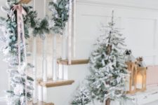 03 decorate your entryway with a flocked Christmas garland and a duo of Christmas trees plus faux fur