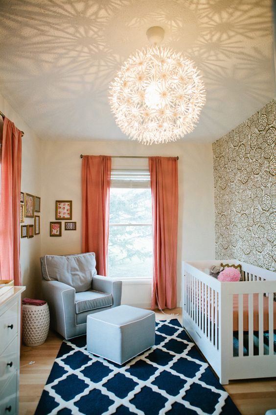 a cozy beachy nursery spruced up with coral curtains for a contrast and a fashionable touch