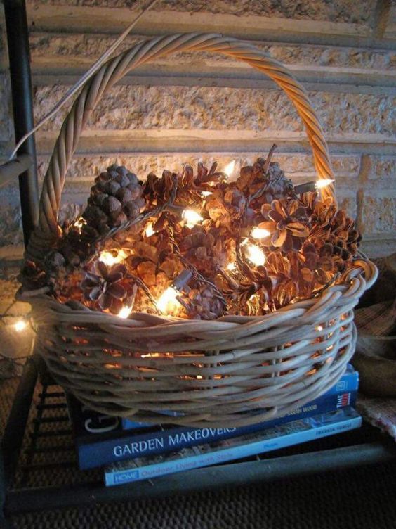 a basket with pinecones and lights is a great idea for a rustic or natural touch