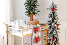 10 a Christmas cart with a plaid towel and a duo of Christmas trees decorated with red birds