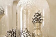 10 a couple of snowy pinecones in metallic cups in a snowy cloche for a winter wonderland touch