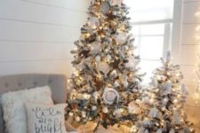 10 a cute duo of flocked Christmas trees with lights, white ornaments and pompoms for a neutral space