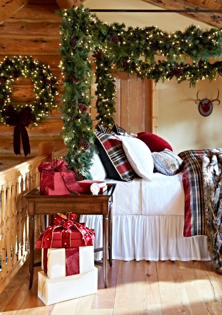decorate your bed poles with an evergreen garland with lights and pinecones to give it a super welcoming holiday look
