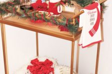 12 a cute and colorful Christmas bar cart styled with faux fur, a sequin gift, evergreens and red touches