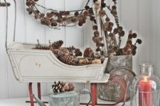 12 a vintage decorative sledge filled with pinecones, a pinecone wreath and an arrangement in a basket for a rustic feel