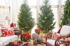 14 a trio of Christmas trees topped wit red birds and with green ornaments for a cozy space