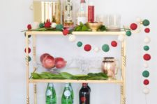 16 simple decor with a large pompom garland and evergreens plus gilded touches