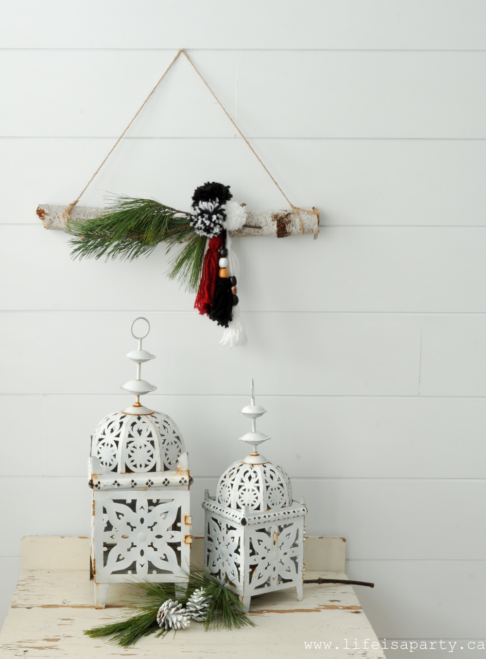 DIY modern boho Christmas wreath with pompoms and tassels with evergreens (via www.lifeisaparty.ca)