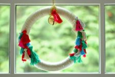 DIY colorful Christmas boho wreath with tassels and jingle bells