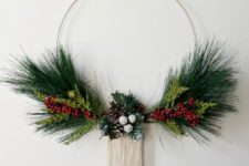 DIY modern Christmas wreath with fake evergreens, berries and long fringe