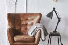 02 a brown wingback leather chair with a cushion is a stylish piece to rock for more comfort
