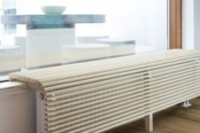 02 a super cool curved wooden plank screen creates an additional seat and covers the radiator too