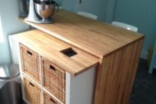 07 IKEA Kallax kitchen island with a countertop and a mobile part with wicker baskets as drawers
