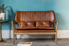 08 a statement brown leather seating with cushions and pillows and warm-colored wood