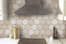 10 a hex tile backsplash in various neutral shades and with black grout makes a neutral space interesting