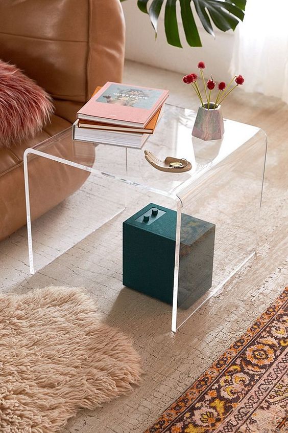 such a curved acrylic side table will add a modern and edgy feel to the space easily