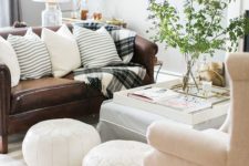 16 white leather Moroccan poufs immediately add interest to your space
