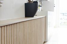 a chic light-stained reeded screen is a perfect idea for a radiator cover as reeded and fluted designs are on top