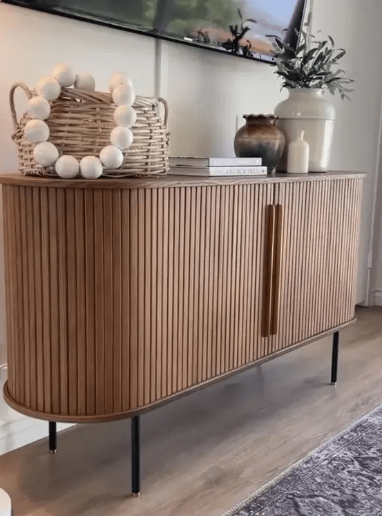 a cool rounded sideboard with fluted appearance and handles, on tall legs is a lovely idea for a modern space