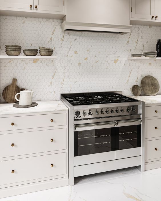 a modern neutral kitchen with a gorgeous hexagon tile backsplash imitating marble, white stone countertops