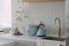 a cute kitchen design with shaker cabients