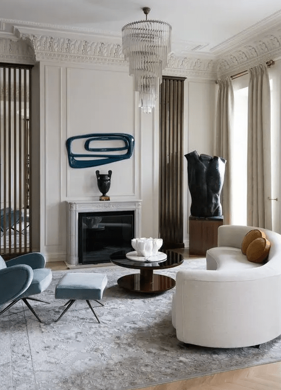 a refined living room with a curved white sofa and catchy decor and artworks that continue the unique style of the room