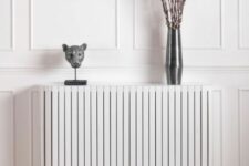 a stylish white planked radiator cover as an elegant console table for an entryway or a living room