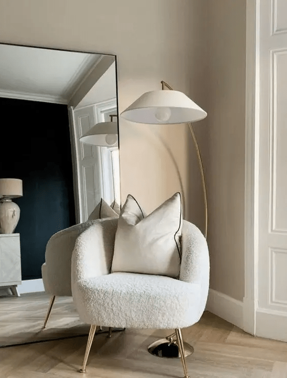 a such a white boucle chair on tall gold legs will make a fashion injection to your space and will make it cooler
