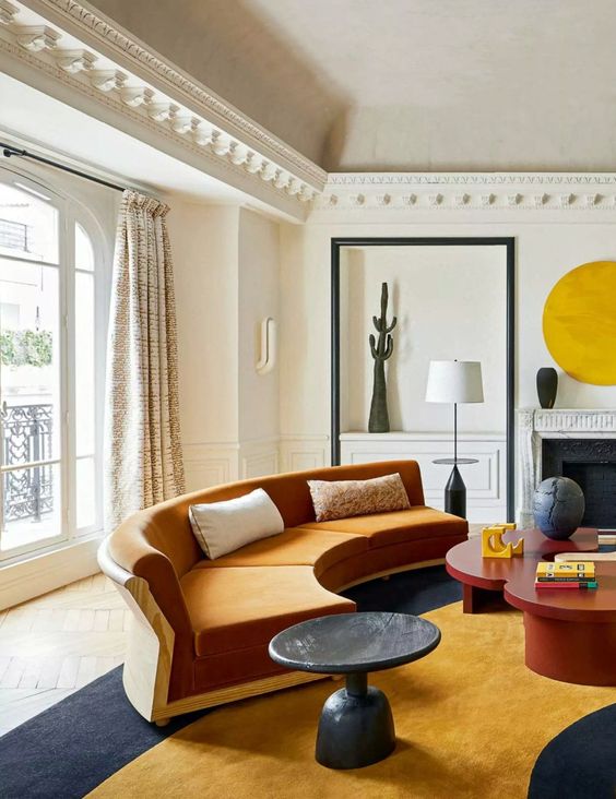 a stylish living room with an orange sofa