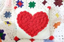 DIY white pillow with a red pompom heart