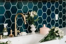 glossy emerald hexagon tiles, brass touches and wood make the kithen super chic