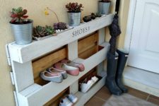 DIY pallet shoe rack with planters on top