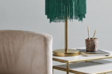 04 a brass lamp with a rounded lampshade and long emerald fringe hanging down for a catchy look