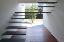 05 a fully floating metal staircase attached to the wall with a large platform floating