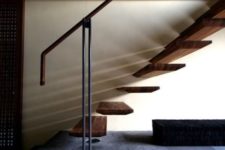 06 a chic floating staircase attached to the wall and metal railing for a bold look