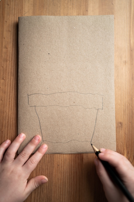 Draw a planter with a pencil on it. Then cut out what you’ve drawn – you’ll get two planters.