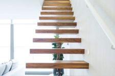 08 a floating staircase with no railing and banister creates a modern floating look than with them