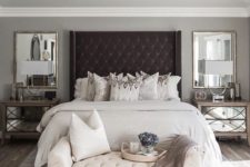 08 an oversized black upholstered wingback headboard takes over the whole neutral bedroom