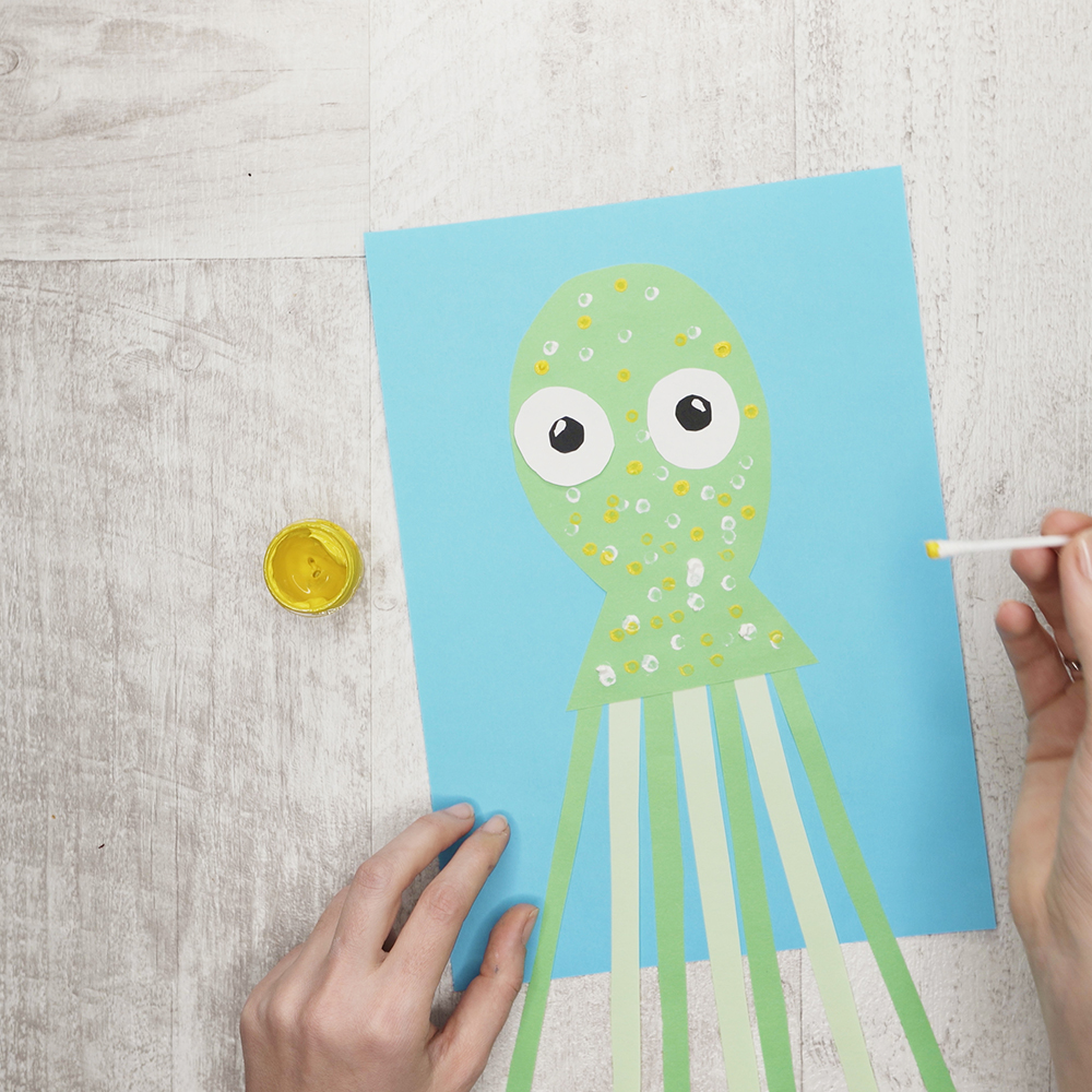 Grab a cotton swab and create a polka dot print on the octopus with white and yellow paint (you may vary the colors).