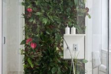 09 a shower with a bright living wall that creates a tropical feeling in the space and makes it breathable