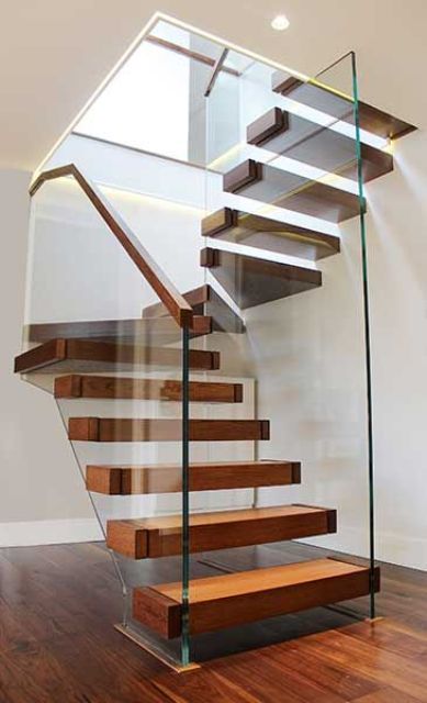 a floating wooden staircase attached to glas banisters with wooden railings looks wow