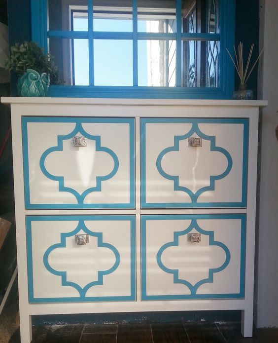 an IKEA Hemnes shoe cabinet renovated with bright stickers gets a personality and character, andmetlalic knobs add to it