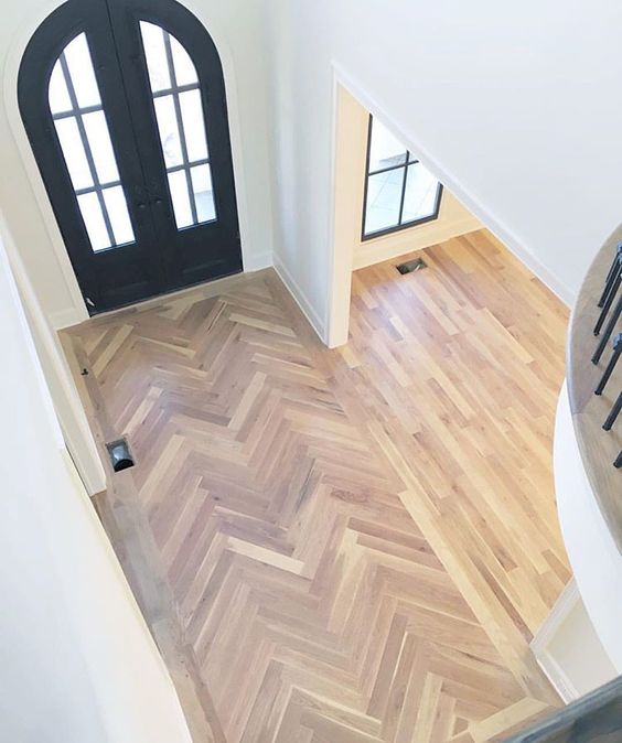 laminate clad in a chevron pattern and more regular laminate in the rest of the space with no gradual transition