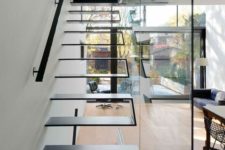 12 an ultra-modern floating staircase of folded metal with a glass wall that makes it safer