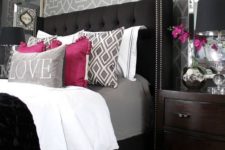 14 a bold bedroom with a black upholstered bed with a tufted wingback headboard with a nail trim
