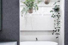 19 a minimalist bathroom with potted greenery over the bathtub is a trendy idea to refresh the laconic look