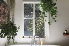20 a couple of potted greenery planters hanging over the tub is a cool idea for every style