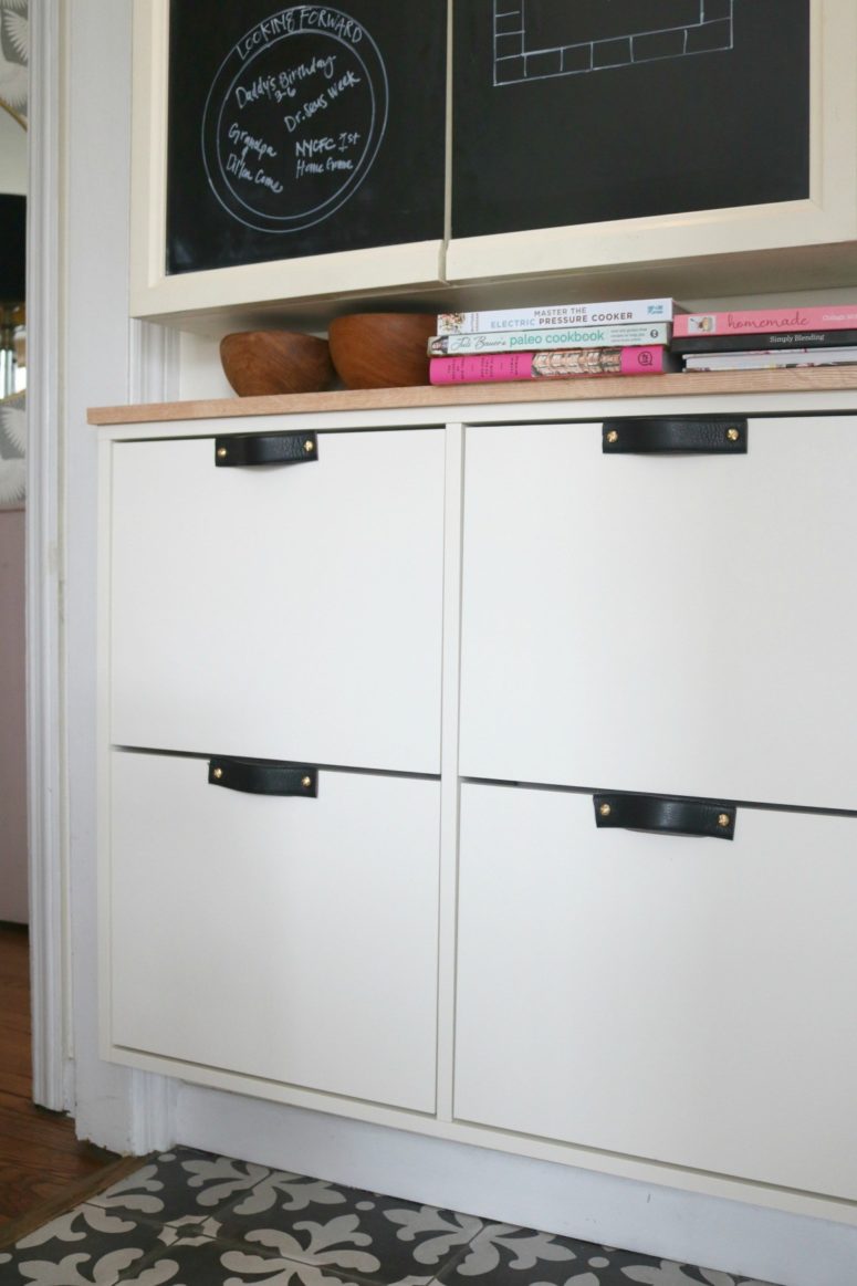 a stylish modern IKEA Stall hack with black leather handles and a wooden countertop for a chic look