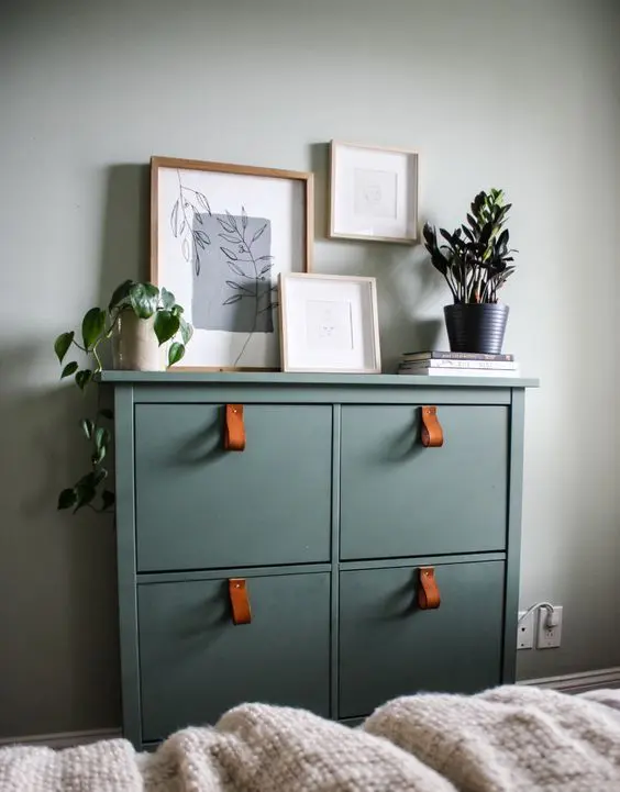 a cool IKEA Hemnes shoe cabinet hack in olive green, with elegant amber leather pulls is a lovely idea