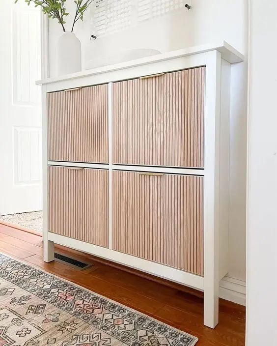 a lovely IKEA Hemnes shoe cabinet hack with fluted wooden panels, gold handles is a stylish and elegant idea